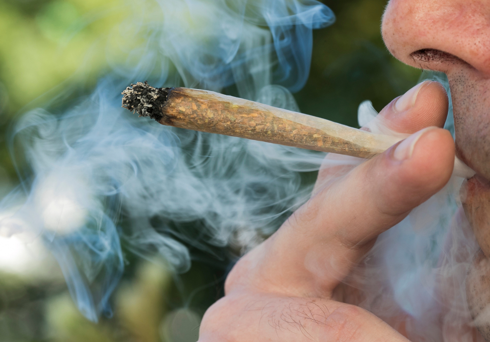 A man smokes a cannabis joint.